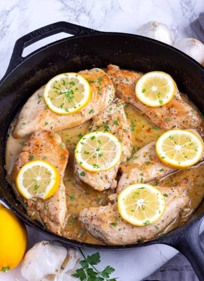 Lemon Garlic Chicken Recipe cooked in a black skillet on the counter