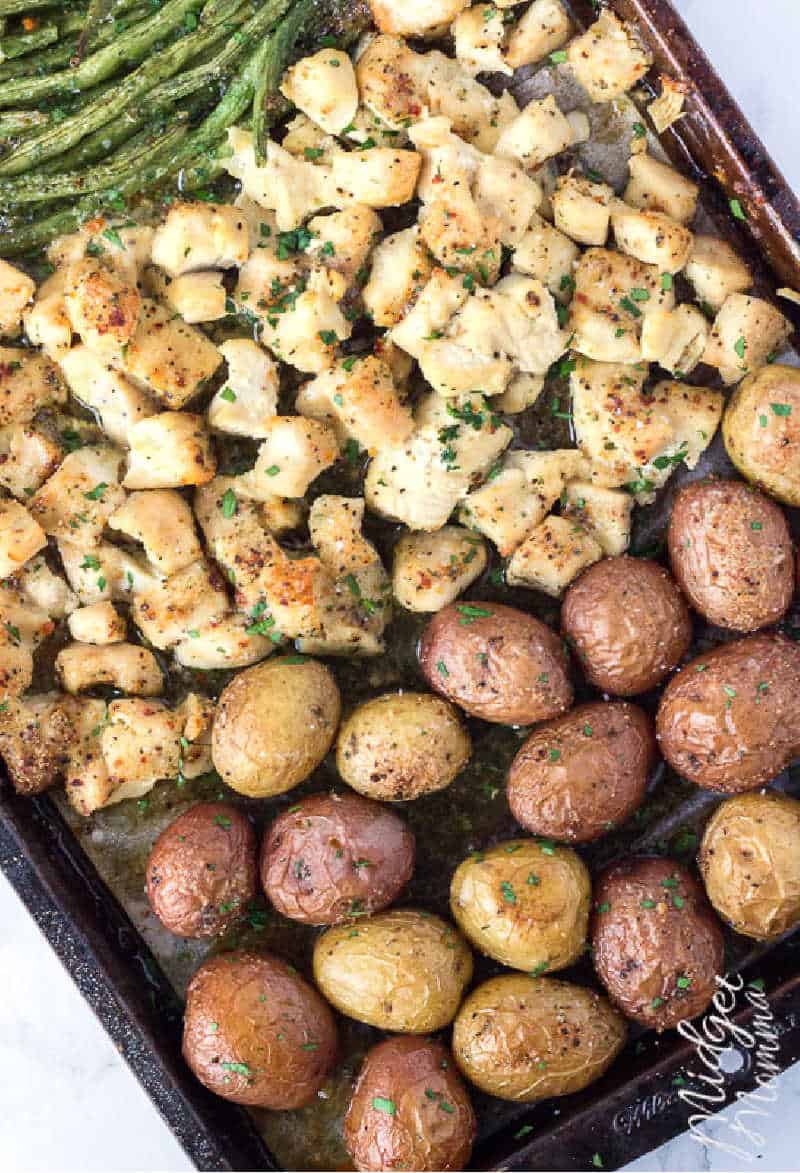 oven baked chicken and potatoes recipe on a baking sheet