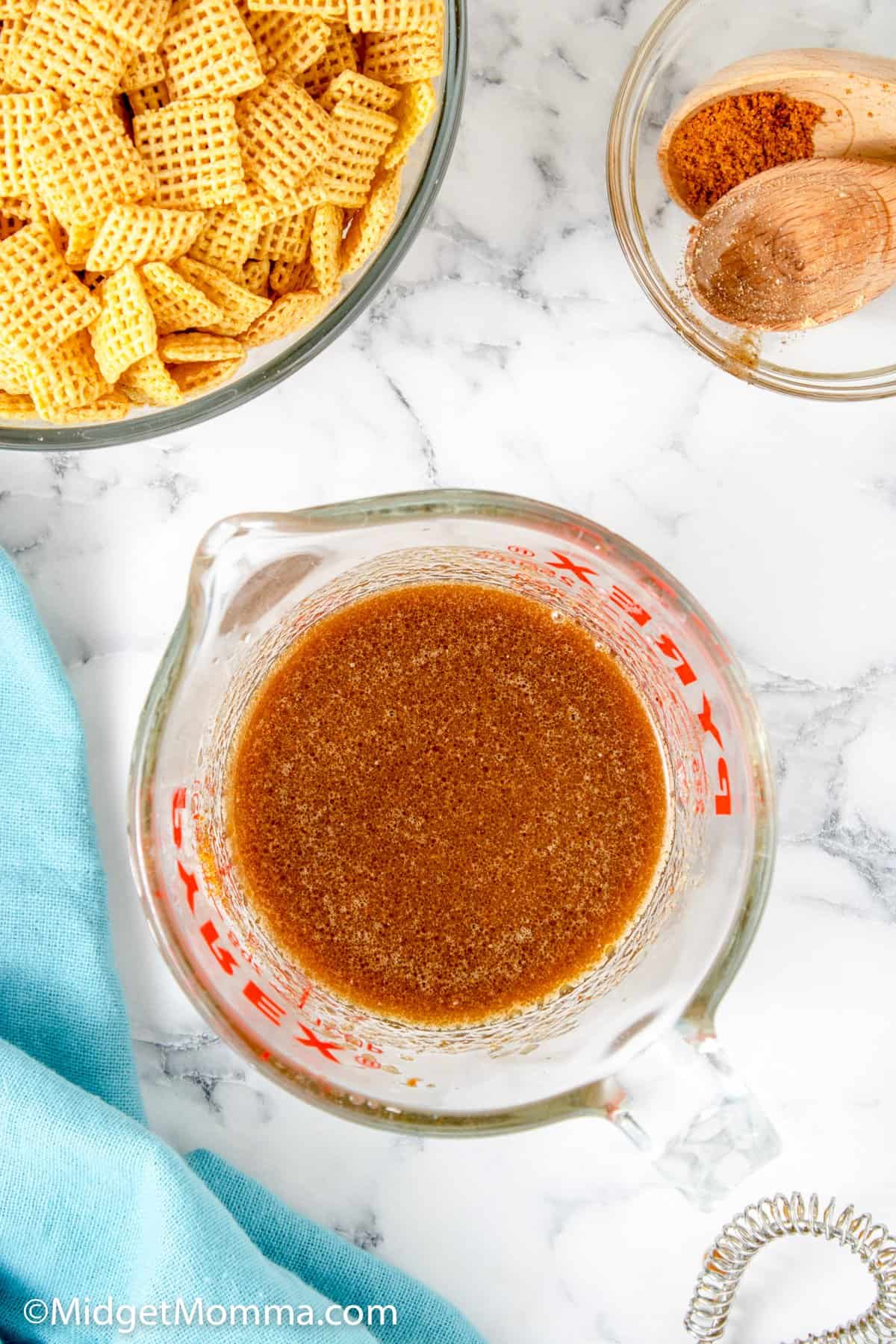 a measuring cup of melted butter and seasonings