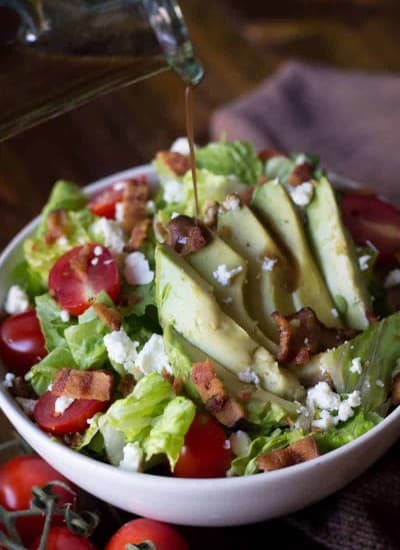 Avocado BLT Salad Recipe with dressing being poured on top