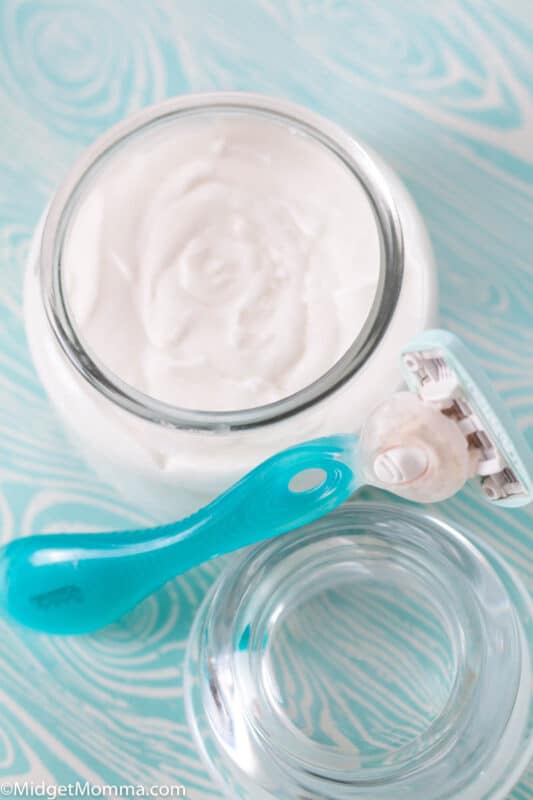 Homemade Shaving cream in a glass jar with a razor
