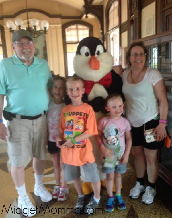 Picture of 3 of Lauren's children with their grandparents at Disney World.