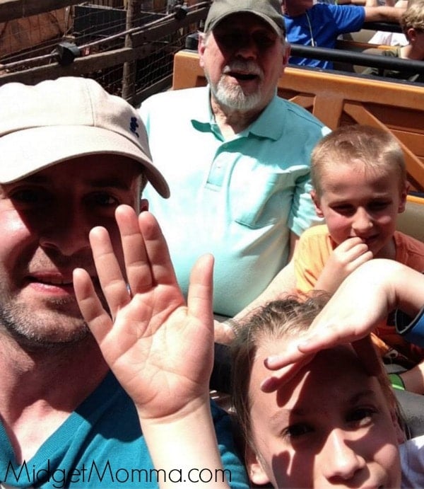 Picture of Tom, two of Lauren's kids, and Lauren's dad on a ride at Disney World.