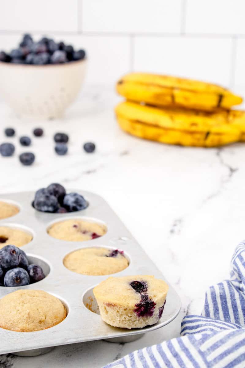 muffin tin with mini blueberry banana muffins