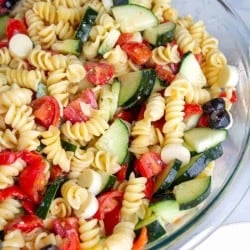 Easy Italian Pasta Salad in a bowl with rotini noodles, cucumbers, olives, tomatoes and italian dressing