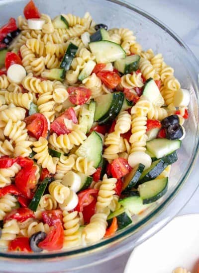 Easy Italian Pasta Salad in a bowl with rotini noodles, cucumbers, olives, tomatoes and italian dressing