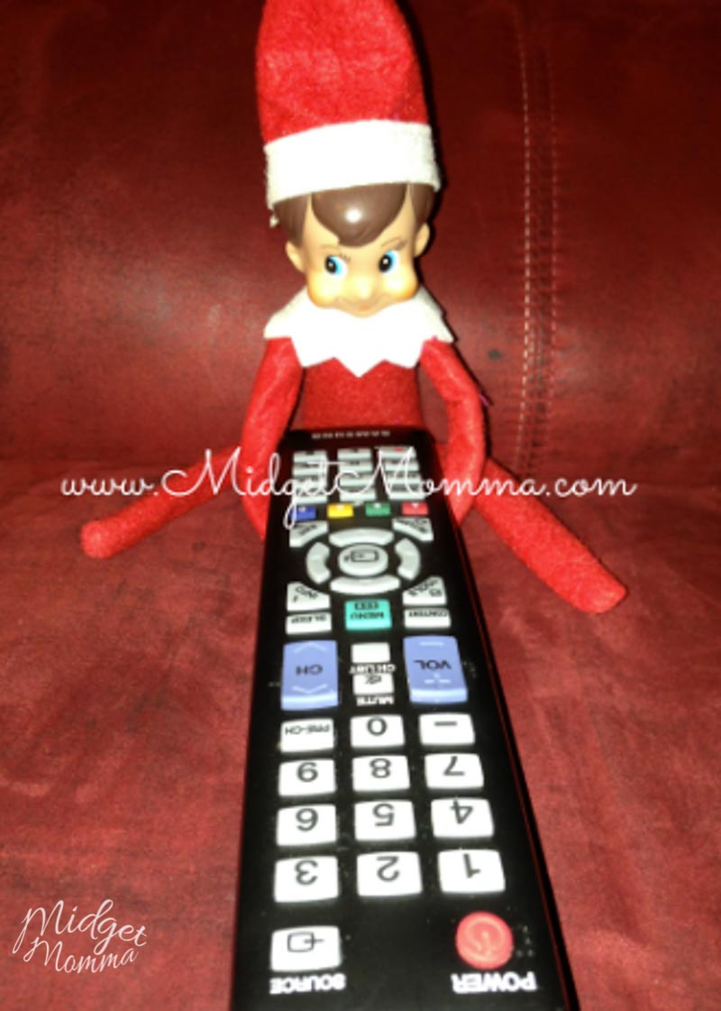 Easy Elf on the Shelf Ideas- the elf steals the remote and is sitting on the couch