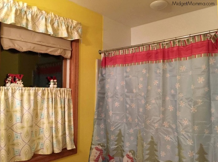 Christmas curtains and shower curtain in a bathroom.