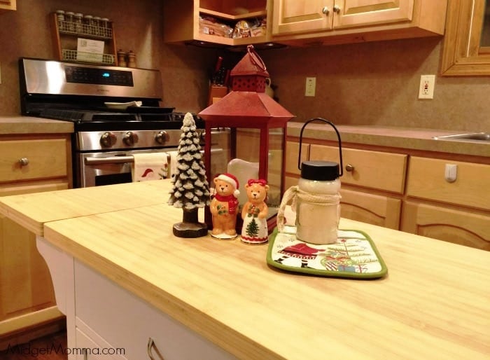 Christmas decorations sitting on an island in a kitchen.