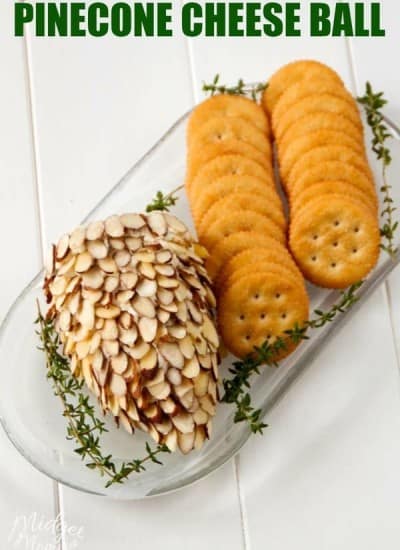 Pinecone cheeseball on a white tray with crackers