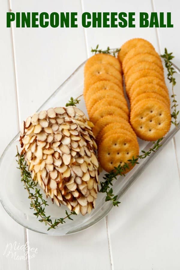 Pinecone cheeseball on a white tray with crackers