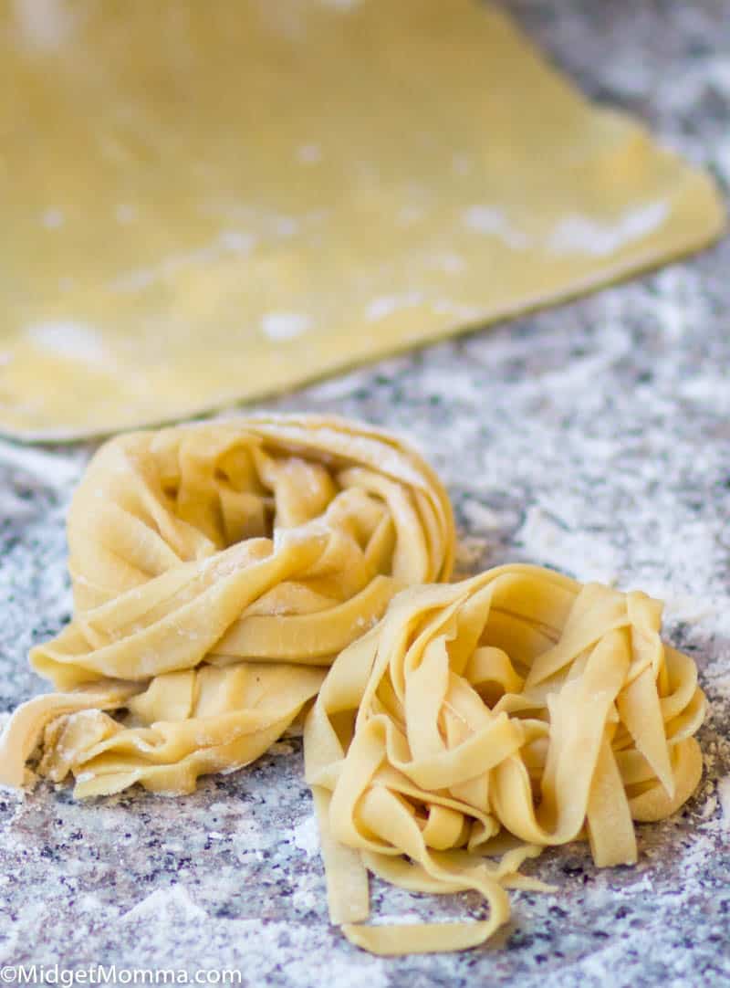 homemade pasta recipe- 2 piles of homemade pasta on a cutting board
