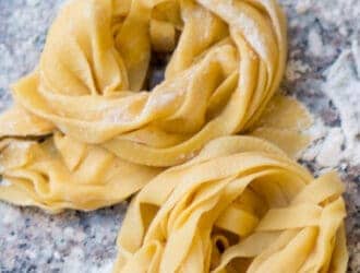 Homemade pasta piles on a cutting board