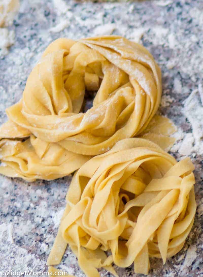 Homemade pasta piles on a cutting board