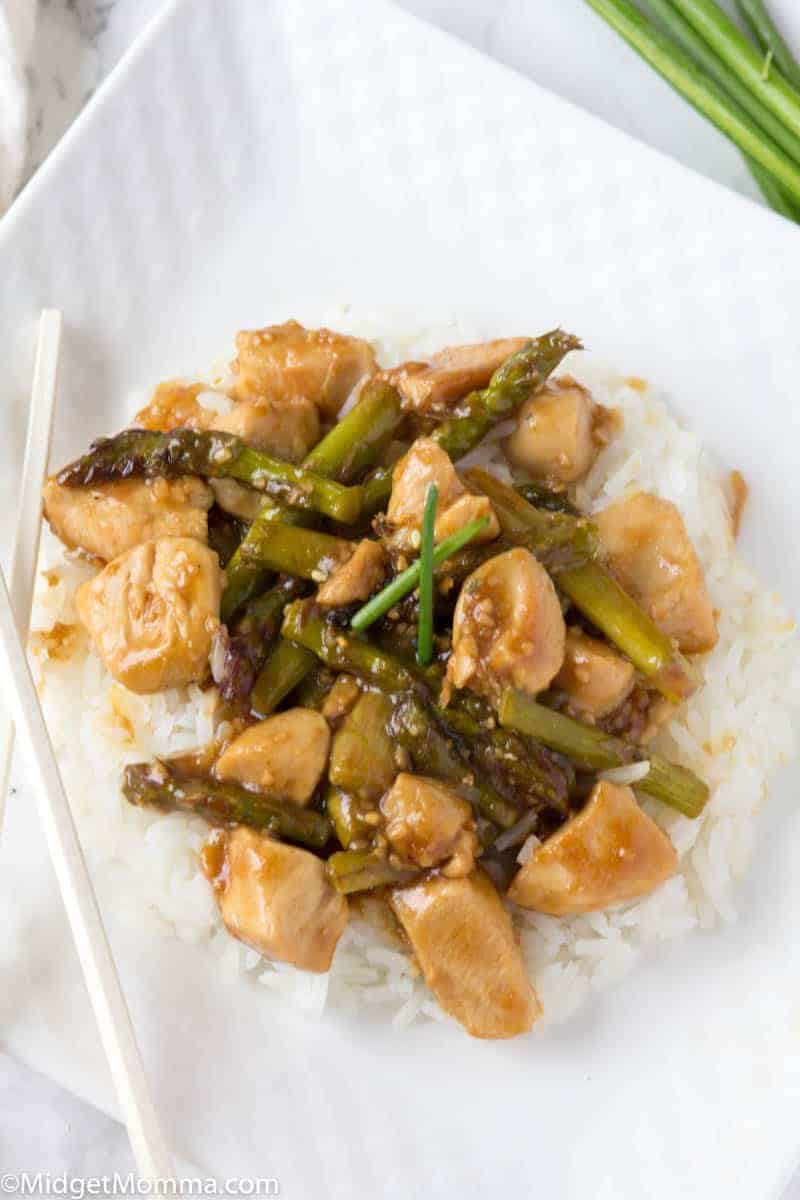 Plate of chicken and asparagus stir fry served over white rice