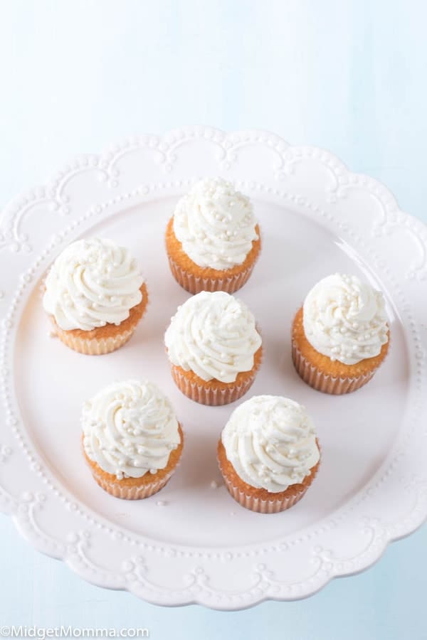 the best vanilla cupcakes topped with vanilla buttercream on a white platter