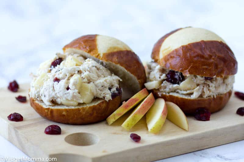 2 chicken salad sandwiches on pretzel buns on a platter