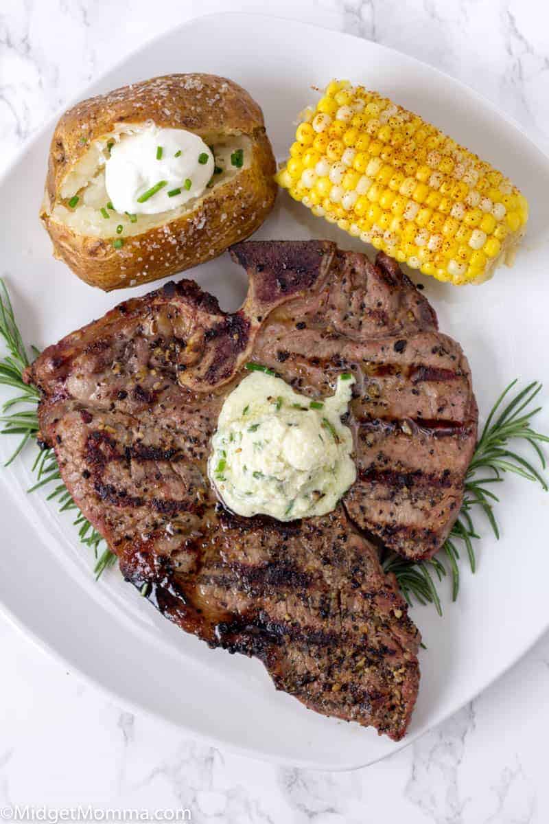 Grilled Steak on a white plate topped with blue cheese butter compound