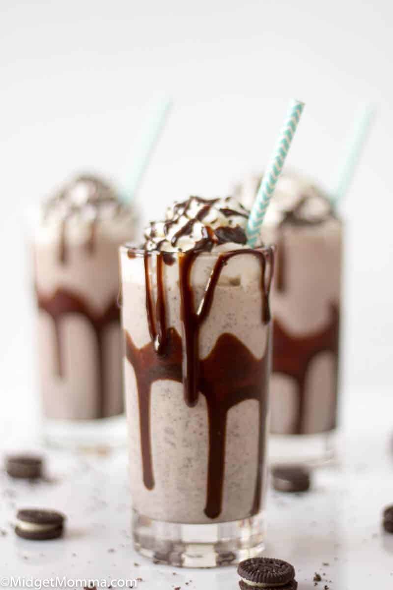 Easy Oreo Milkshake Recipe in a glass with a blue and white straw