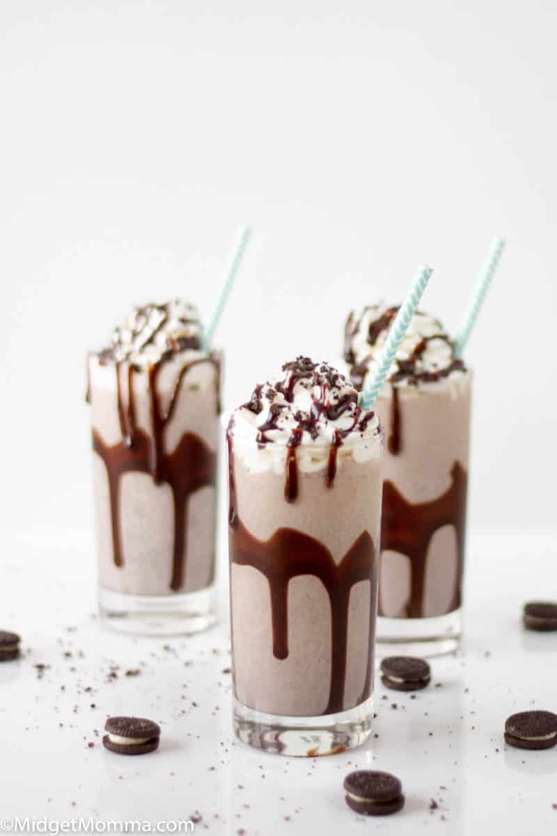 How to Make and Oreo Milkshake - 3 oreo milkshakes in glasses topped with whipped cream and chocolate shreds