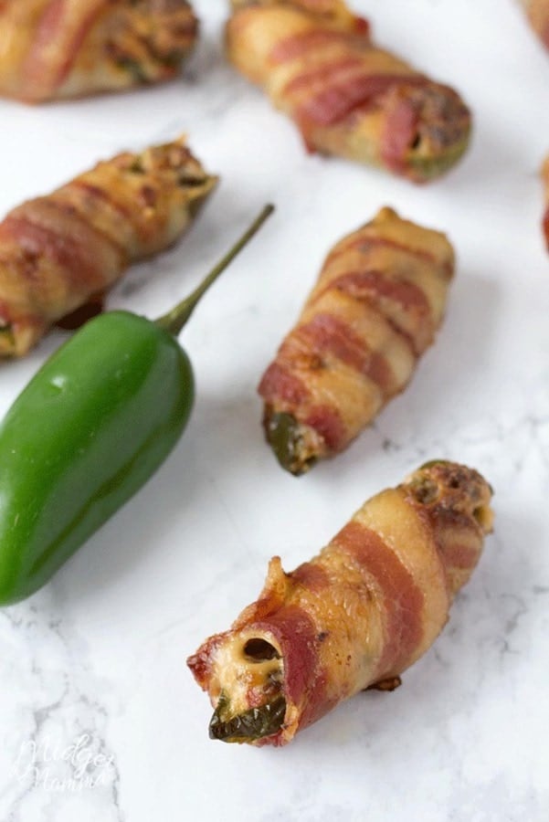 Jalapenos poppers stuffed with cream cheese and sausage wrapped in bacon