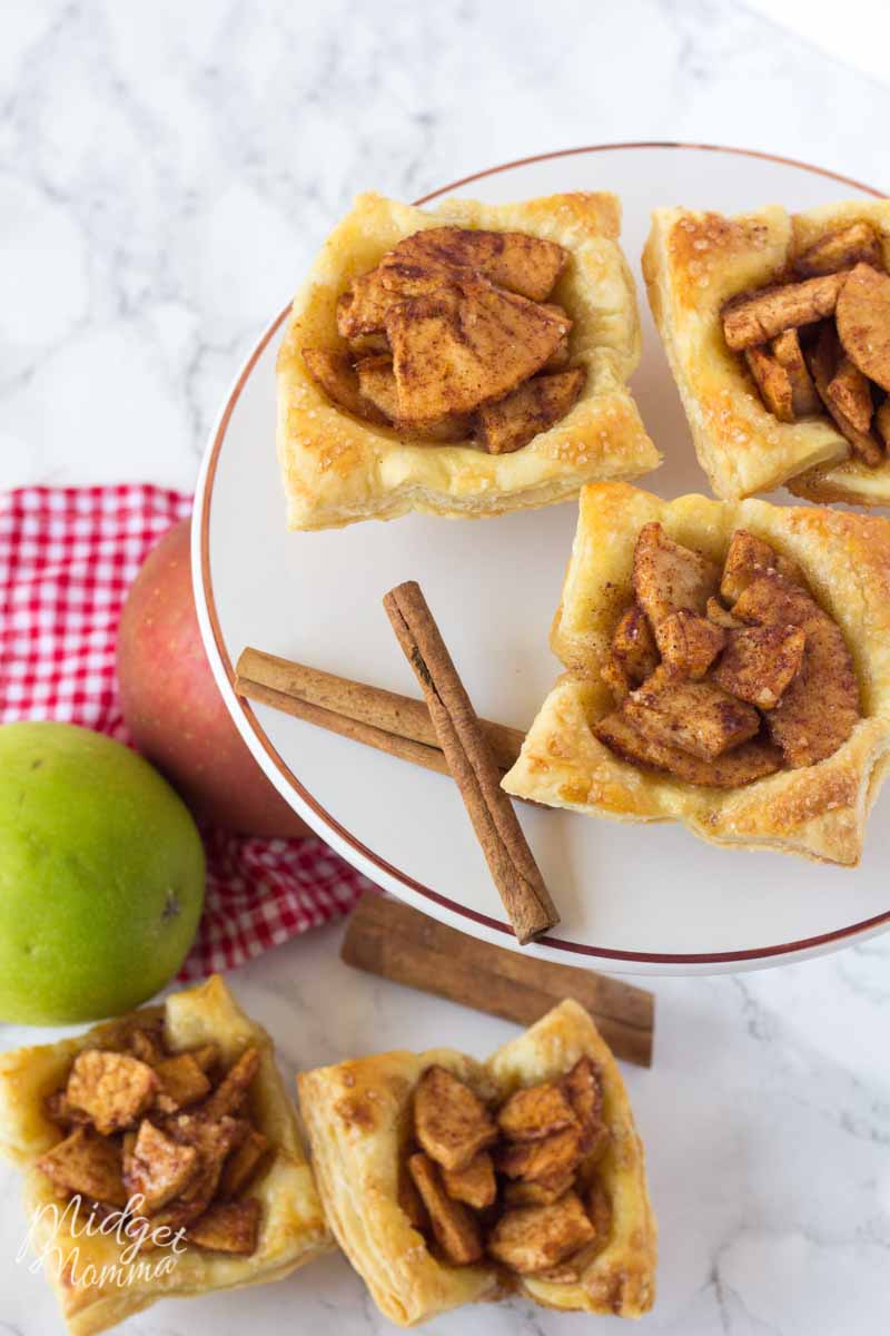 apple puff pastry on a plate with cinnamon sticks