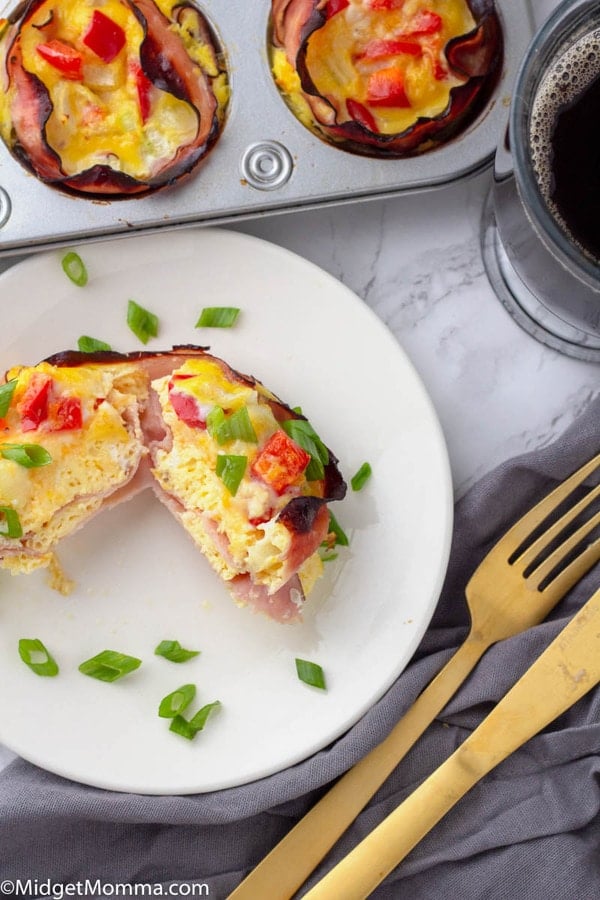 egg breakfast cups cooked with a few in the muffin tin and one on a plate with a cup of coffee