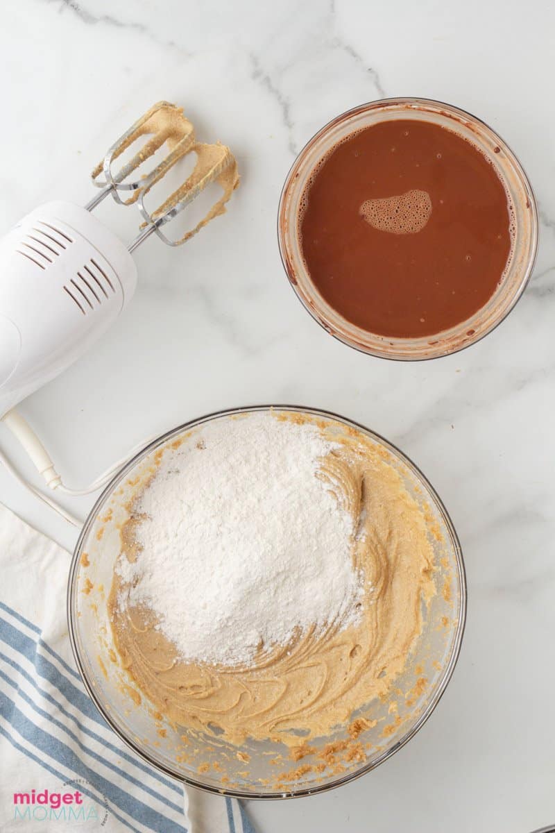 dry ingredients mixture being added to the brown sugar, granulated white sugar and butter mixture bowl