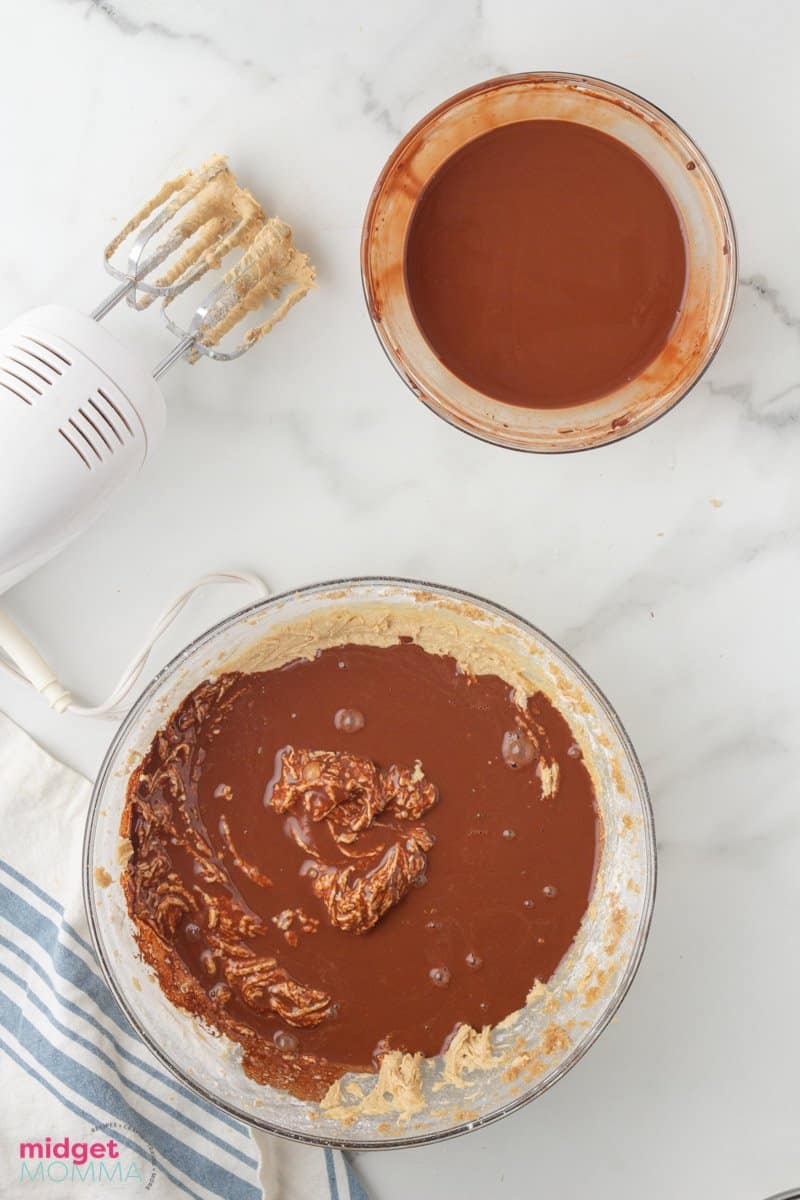 Coffee and cocoa power mixture being added to the brown sugar, granulated white sugar and butter mixture bowl