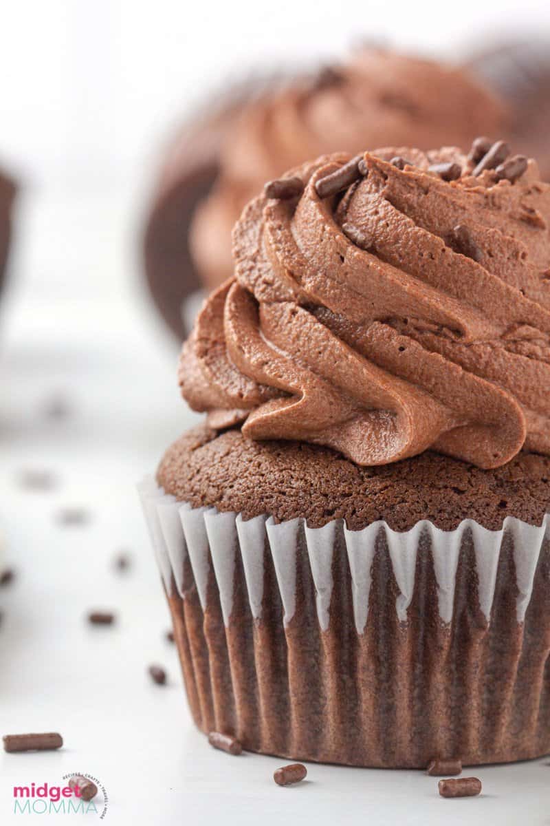 close up photo of chocolate cupcake with chocolate buttercream frosting and chocolate sprinkles