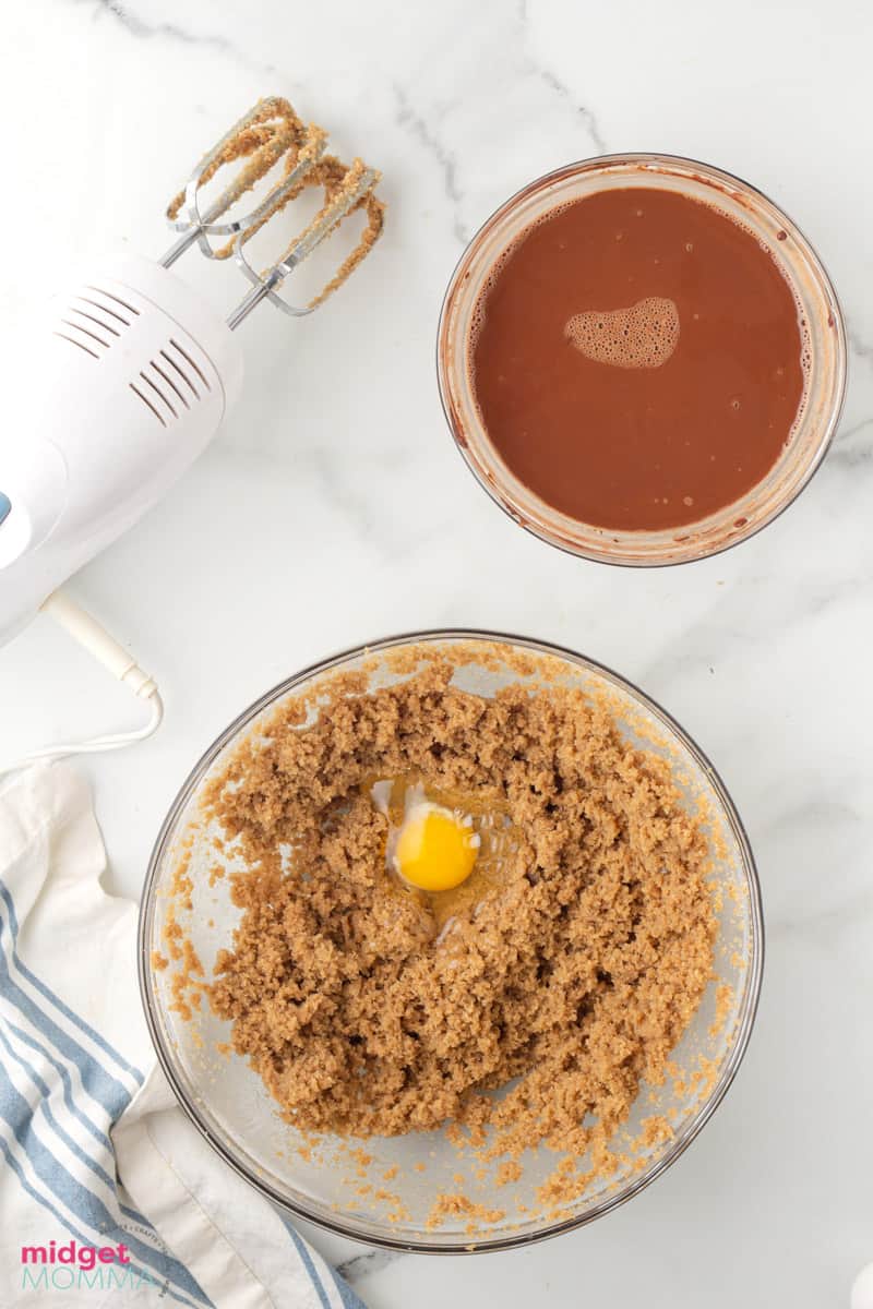 egg added to the brown sugar, granulated white sugar and butter in a clear glass bowl