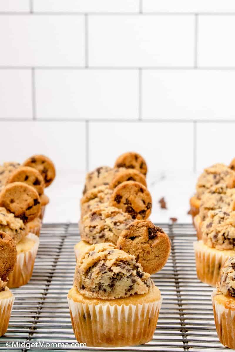 Front photo of Chocolate Chip Cupcakes frosted with chocolate chip cookie dough frosting on a baking rack