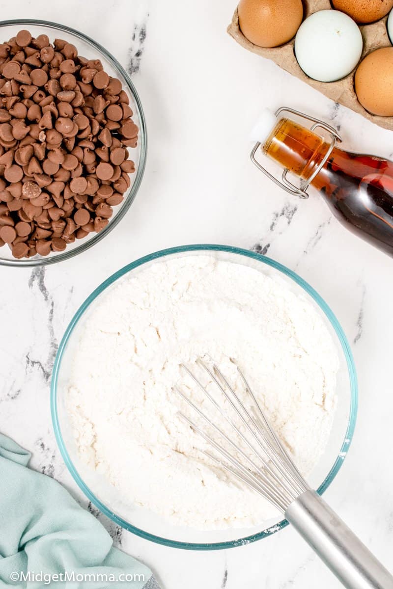 dry ingredients for cupcakes in a bowl with a whisk