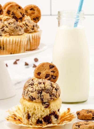 Chocolate Chip Cupcakes with the wrapper pulled off and a glass of milk