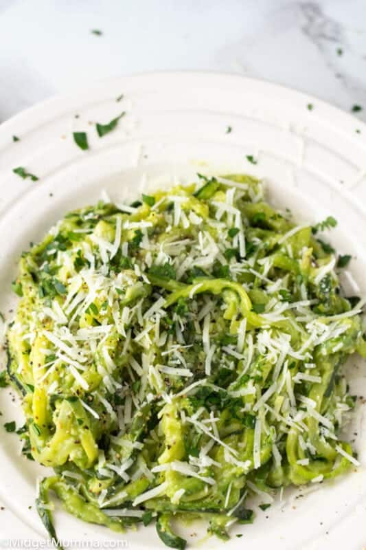 Garlic Avocado Sauce over zoodles on a white plate