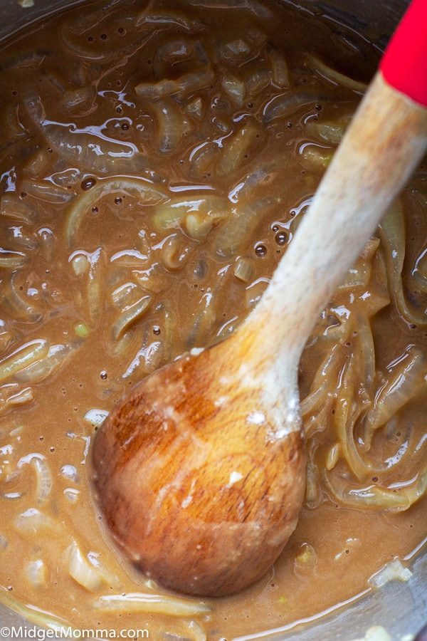 bangers and mash onion gravy cooking in a pot