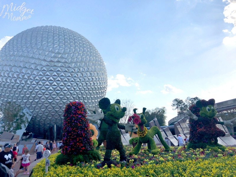 Bright colored flower statures of mickey mouse, minnie mouse, and goofy at the Disney Flower and Garden Festival