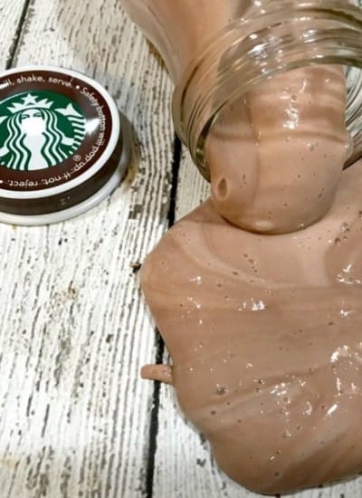 Slime with brown Paint oozing out of a glass bottle