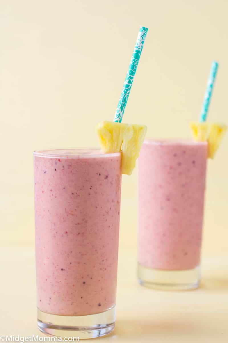 tropical smoothie with strawberries, mangos, banana and pineapple in a glass
