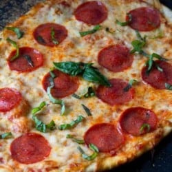 This homemade pepperoni pizza is a family favorite! Made with homemade pizza dough, this makes not only for a tasty dinner but family fun while everyone gets involved making homemade pizza. #Pizza #HomemadePizza #pepperoni #HomemadeCrust #PizzaSauce #PizzaCrust #pepperoniPizza