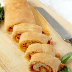 Pizza bread is made with pizza crust, pizza sauce, cheese and your favorite toppings. All rolled together, baked and then cut into slices. #Pizza #lunch #EasyRecipe #PizzaRecipe