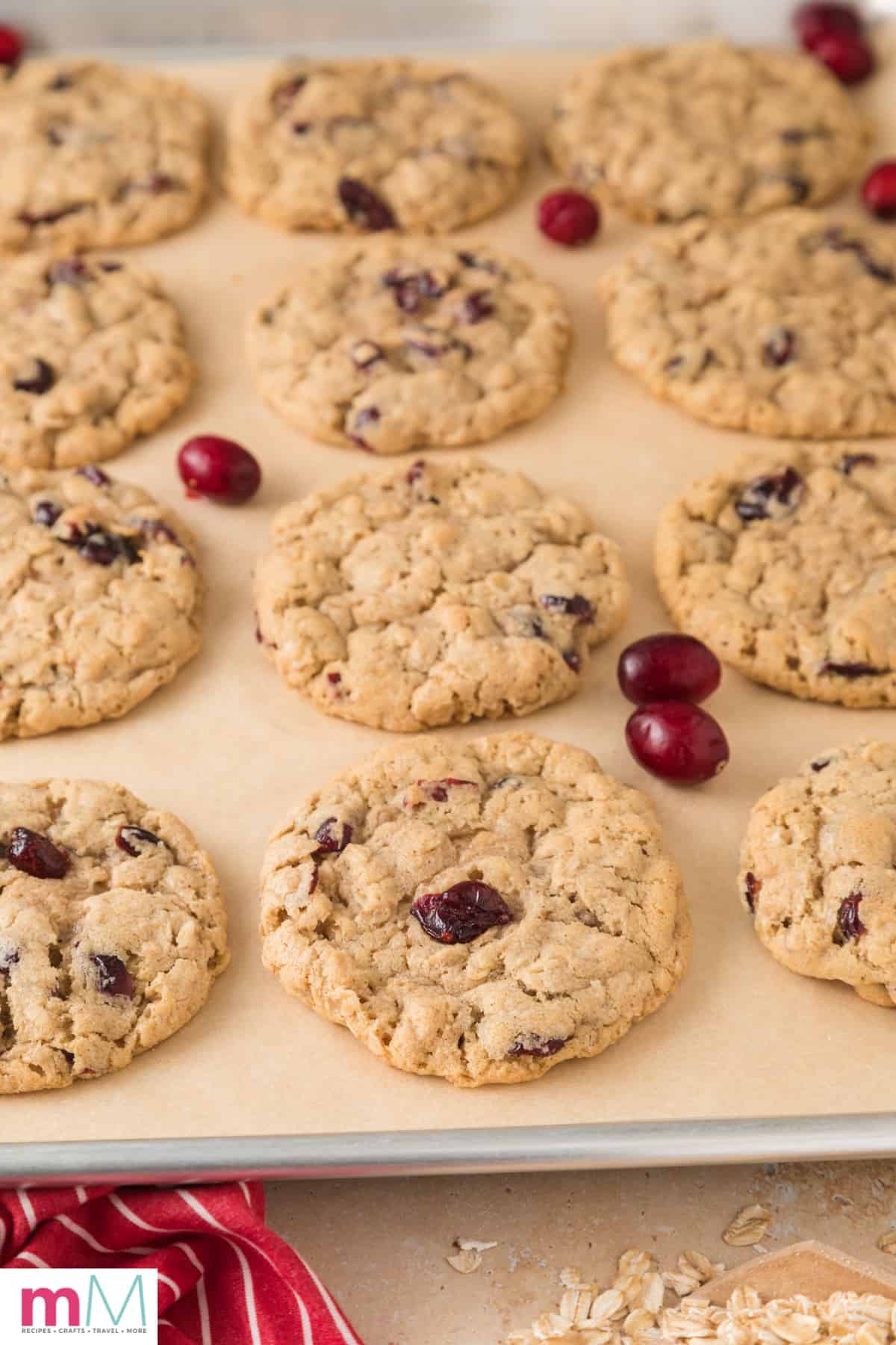 Soft and Chewy Cranberry Oatmeal Cookies on a baking sheet fresh out of the oven