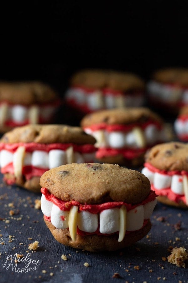 Chocolate chip cookies, with red frosting, marshmallows and almonds to form a vampire mouth
