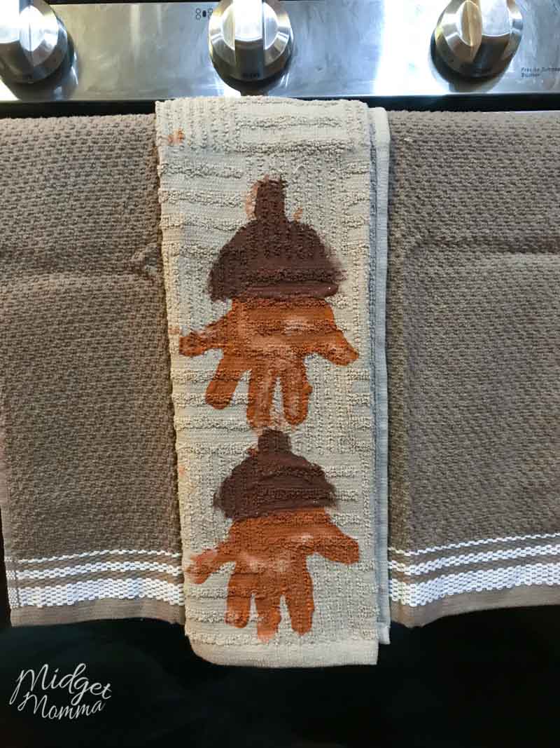 Acorn Handprint Towel hanging from the stove