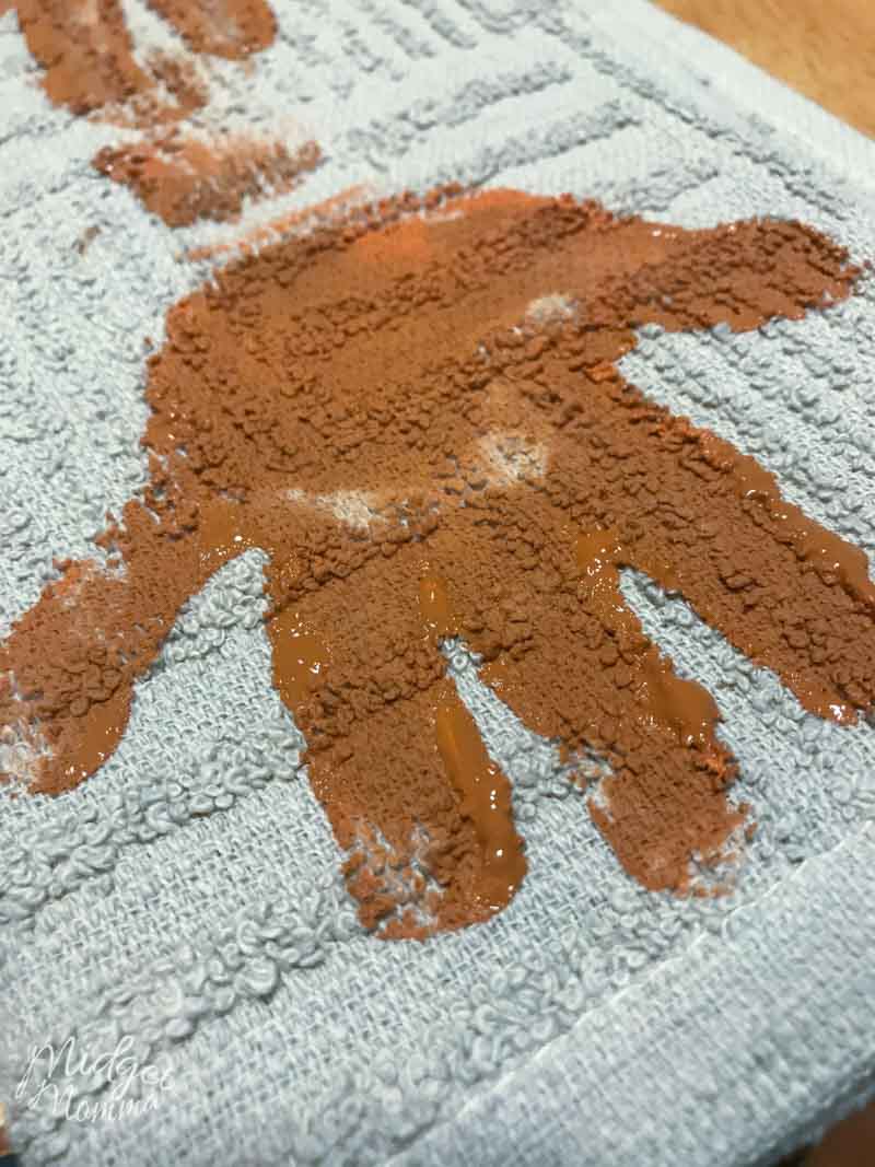 brown kids handprint on a kitchen towel