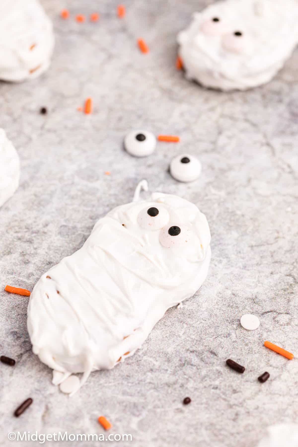 close up photo of Chocolate Dipped Nutter Butter Mummy Cookies