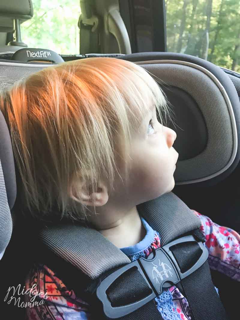 child looking out the window while extended rear facing in the chicco nextfit carseat