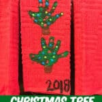 handprint Christmas Tree towel hanging on the stove door in the kitchen