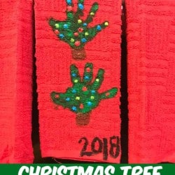 handprint Christmas Tree towel hanging on the stove door in the kitchen