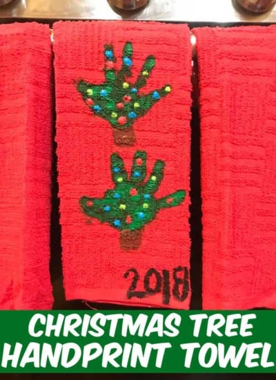 handprint Christmas Tree towel hanging on the stove door in the kitchen